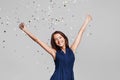 Beautiful happy woman at celebration party with confetti falling everywhere on her. Birthday or New Year eve celebrating concept Royalty Free Stock Photo