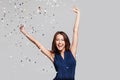Beautiful happy woman at celebration party with confetti falling everywhere on her. Birthday or New Year eve celebrating concept Royalty Free Stock Photo