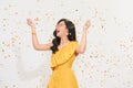 Beautiful happy woman at celebration party with confetti falling everywhere on her. Birthday or New Year eve celebrating concept Royalty Free Stock Photo