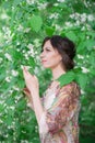 Beautiful happy woman enjoying smell in a flowering spring garden Royalty Free Stock Photo