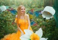 Beautiful happy woman fairy nymph sitting on forest. Magical fantasy wings costume pixie butterflies. Elf girl princess Royalty Free Stock Photo