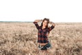 Beautiful happy woman in field, sunny afternoon, shorts shirt. Beautiful hair, tanned skin, concept of enjoying nature Royalty Free Stock Photo