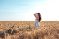 Beautiful happy woman field, sunny afternoon, white dress. Brunette hair, tanned skin, concept of enjoying nature. Happy Royalty Free Stock Photo