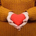 Beautiful happy woman holding heart in hands against gray background Royalty Free Stock Photo