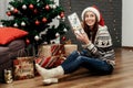 Beautiful happy woman holding surprised christmas present box. g Royalty Free Stock Photo