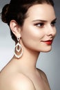 Beautiful happy woman in luxury fashion earrings. Diamond shiny jewelry with brilliants. retro style portrait