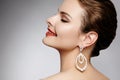 Beautiful happy woman in luxury fashion earrings. Diamond shiny jewelry with brilliants. retro style portrait