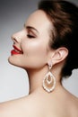 Beautiful happy woman in luxury fashion earrings. Diamond shiny jewelry with brilliants. retro style portrait