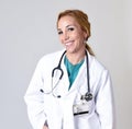 Beautiful and happy woman md doctor or nurse posing smiling cheerful with stethoscope Royalty Free Stock Photo