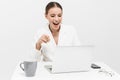 Beautiful happy woman posing isolated over white wall background using laptop computer pointing Royalty Free Stock Photo