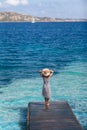 Beautiful happy woman relaxing on pier in Sardinia island, Italy Royalty Free Stock Photo