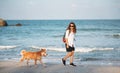 Beautiful Happy Woman Running With Her Dog. Girl Enjoying Summer Holidays Vacations, Having Fun With Her Pet. Summertime Concept Royalty Free Stock Photo