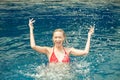 Beautiful Happy woman splashing water in swimming pool ,lady in Royalty Free Stock Photo