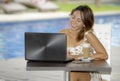 Beautiful happy woman in Summer dress outdoors at nice coffee shop having breakfast networking or working with laptop computer Royalty Free Stock Photo