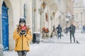 Beautiful happy woman walks around the city drinking coffee in winter city Royalty Free Stock Photo
