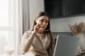 Beautiful happy woman working at home with laptop . Smiling business woman woman wearing eyeglasses in office using computer Royalty Free Stock Photo