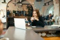 Beautiful happy woman working on laptop computer during coffee break in cafe bar Royalty Free Stock Photo