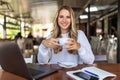 Beautiful happy woman working on laptop computer during coffee break in cafe shop Royalty Free Stock Photo