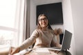 Beautiful happy woman working . Smiling business woman woman wearing eyeglasses in office, using laptop computer Royalty Free Stock Photo