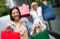 Beautiful happy women with shopping bags walking at the mall Royalty Free Stock Photo