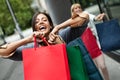 Beautiful happy women with shopping bags walking at the mall Royalty Free Stock Photo