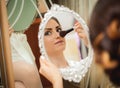 Beautiful young bride sitting near mirror Royalty Free Stock Photo