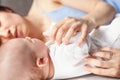 Beautiful happy young brunette woman hugging her newborn baby, c Royalty Free Stock Photo