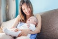 Beautiful happy young brunette woman with newborn baby on her ha Royalty Free Stock Photo