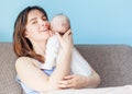 Beautiful happy young brunette woman with newborn baby on her ha Royalty Free Stock Photo