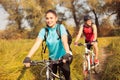 Happy young woman riding mountain bike with her boyfriend Royalty Free Stock Photo