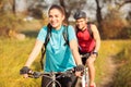 Happy young woman riding mountain bike with her boyfriend Royalty Free Stock Photo