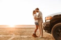 Beautiful young couple standing at the sunny beach Royalty Free Stock Photo