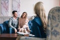 Beautiful and happy young couple visiting psychologist for relationship counselling. Royalty Free Stock Photo