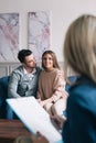 Beautiful and happy young couple visiting psychologist for relationship counselling. Royalty Free Stock Photo