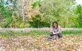 Beautiful happy young girl with her Yorkshire terrier dog puppy enjoying and playing in the autumn day in the park selective focus Royalty Free Stock Photo