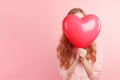 beautiful happy young girl holding a red heart-shaped balloon. Valentine\'s day, mother\'s day, women\'s Day card Royalty Free Stock Photo