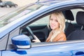 Beautiful happy young girl sitting in the car Royalty Free Stock Photo