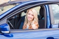 Beautiful happy young girl sitting in the car Royalty Free Stock Photo