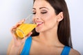 Beautiful happy young healthy casual woman drinking orange juice Royalty Free Stock Photo