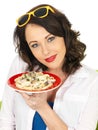 Beautiful Happy Young Hispanic Woman Holding a Plate of Spaghetti Carbonara Cream Pasta Royalty Free Stock Photo