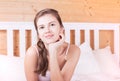 Beautiful happy young long haired woman waking up in the morning and stretching in bed at home Royalty Free Stock Photo