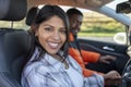 happy young loving couple holding hands and smiling while sitting in their car Royalty Free Stock Photo