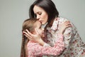 Beautiful and happy young mother kissing her small daughter. Royalty Free Stock Photo