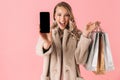 Beautiful happy young pretty woman posing isolated over pink wall background showing display of mobile phone Royalty Free Stock Photo