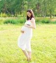 Beautiful happy young smiling pregnant woman in white dress Royalty Free Stock Photo