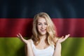 Beautiful happy young woman against the germany flag background. Live, education and work in United Germany