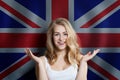 Beautiful happy young woman against the UK flag background. Live, education and work in United Kingdom