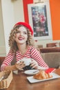 Beautiful happy young woman drinking coffee in european cafe Royalty Free Stock Photo