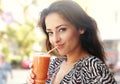 Beautiful happy young woman drinking healthy smoothie juice outdoor background. Closeup portrait Royalty Free Stock Photo