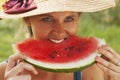 Beautiful happy young woman eating watermelon. Vitamins, nutritional vegetarian food, holiday, diet concept. Royalty Free Stock Photo